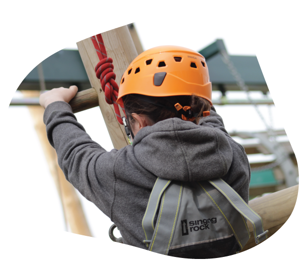 A boy climbing low ropes